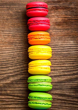 Colorful Macarons Stacked on Wood