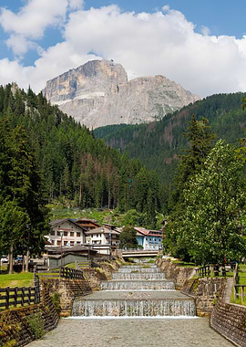 Sass Pordoi with cascading river, view from Canazei - Italy