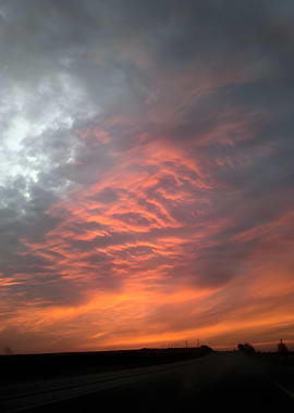 Red sunset over a dark road