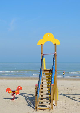 Beach playground with slide and spring rider