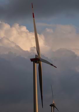 Wind Turbines Against Cloudy Sky