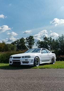 White Nissan Skyline R34 on grass
