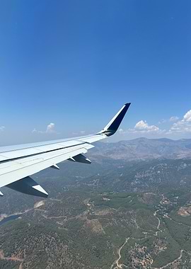 Airplane wing view over landscape