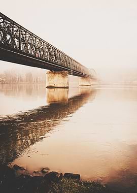 Bridge over water in foggy weather