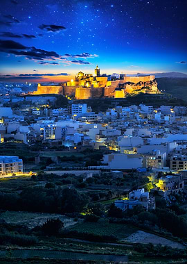 Illuminated Citadel Overlooking City at Night in Gozo