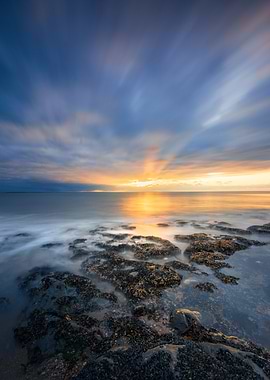 Coastal Sunset with Rocks and Water