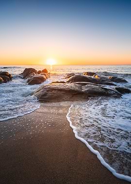 Sunset over rocky beach