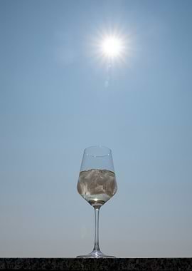 Wine Glass with Ice Against Blue Sky