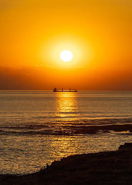 Golden Sunset Over Ocean with Ship