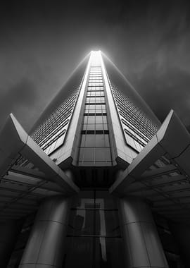 Monochrome Skyscraper Ascending into Cloudy Sky