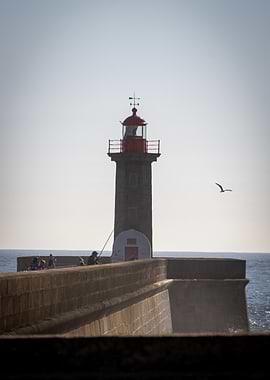 Lighthouse with People Fishing