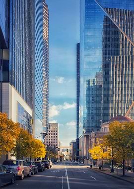 Downtown street with skyscrapers and autumn trees
