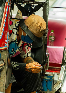 Man in Tricycle with Face Mask