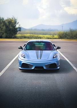 Blue Ferrari on Asphalt Road