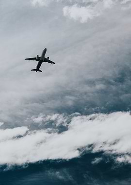 Airplane in Cloudy Sky