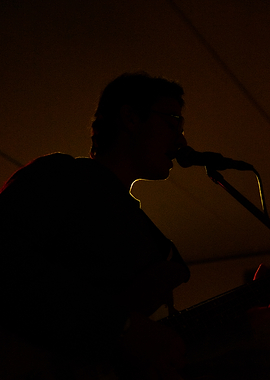 Silhouette of Musician Singing into Microphone