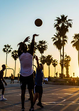 Basketball game at sunset with palm trees