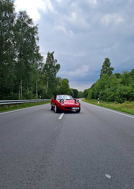 Red Mazda Miata on Country Road