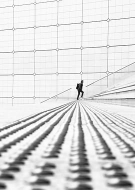 Monochrome Ascent: Man on Textured Stairs