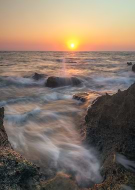 Ocean Sunset with Rocks and Waves