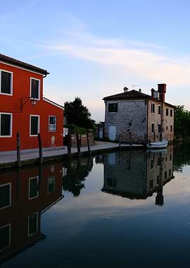 Venice Torcello canal with colorful buildings reflection