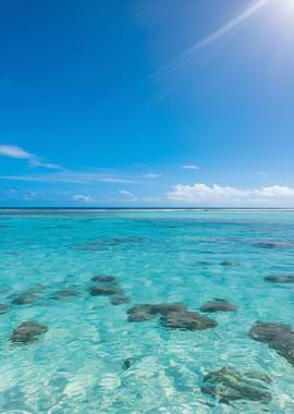 Turquoise Ocean with Rocks and Blue Sky