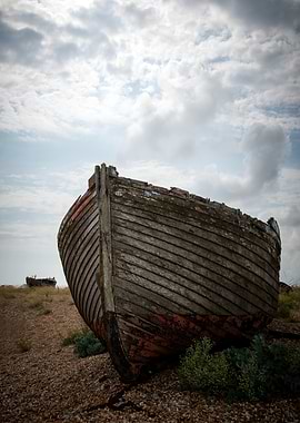Abandoned boat on pebble beach