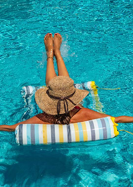 Woman relaxing on pool float in water