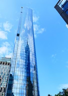Modern glass skyscraper against blue sky