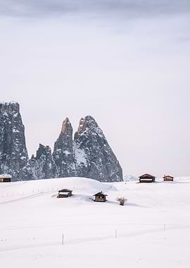 Winter landscape with mountains and huts