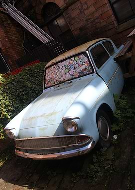 Vintage Blue Car with Sticker-Covered Windshield