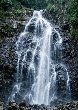 Waterfall cascading down rocky terrain
