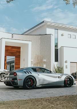 Silver Ferrari in front of modern house