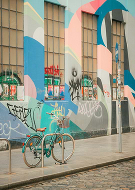 Turquoise Bicycle Parked Against Graffiti Wall Pastel
