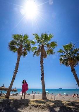 Woman on a sunny beach with palms