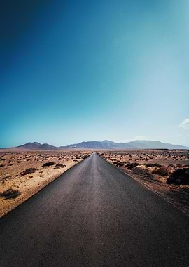 Desert Road Under Clear Blue Sky