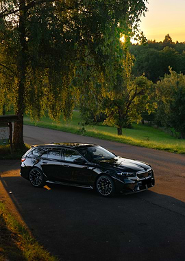 Black BMW M5 Touring on Country Road
