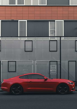Red Car Against Modern Building
