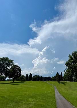 Green field with stormy sky