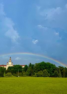Rainbow over a building and field