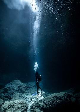 Underwater Scuba Diver in Dark Ocean