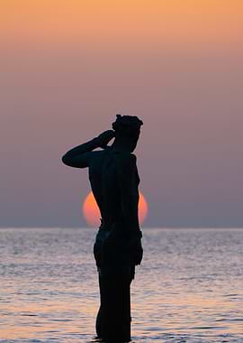 Statue Silhouette at Sunset by the Sea