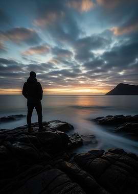 Man on Rocky Coast at Sunset