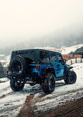 Blue Jeep Wrangler in Snowy Landscape