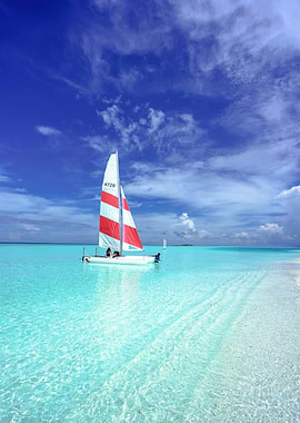 Sailboat on turquoise water under blue sky