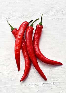 Red Chili Peppers on White Wood