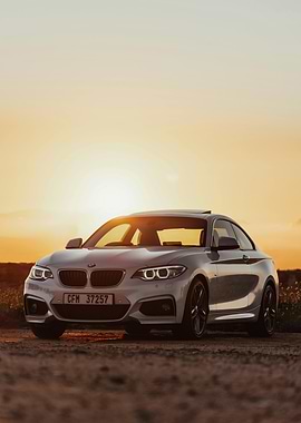 Silver BMW Coupe at Sunset