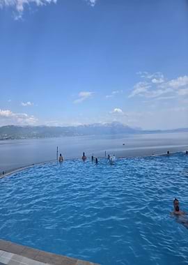 Infinity Pool Overlooking Lake and Mountains