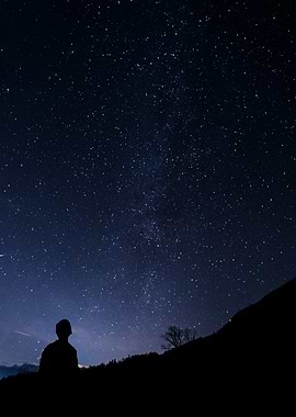 Silhouette Gazing at Starry Night Sky