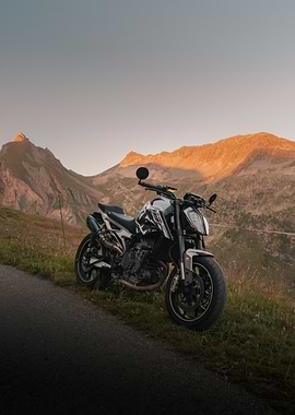 Motorcycle in Mountain Landscape at Sunset